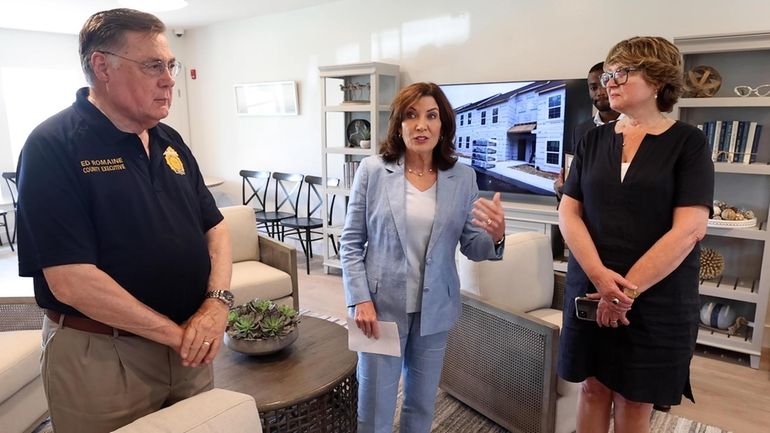 Gov. Kathy Hochul, center, with Suffolk County Executive Edward P....