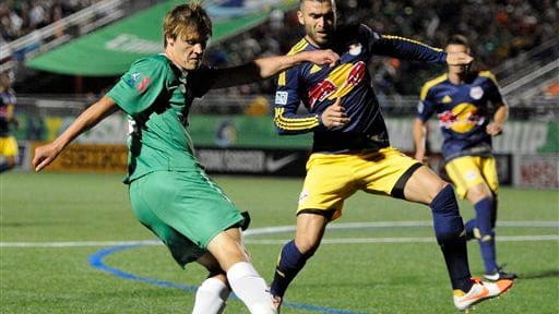 The Cosmos' Mads Stokkelien kicks the ball against the Red...