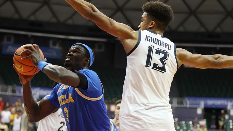 UCLA forward Adem Bona (3) goes to the net over...