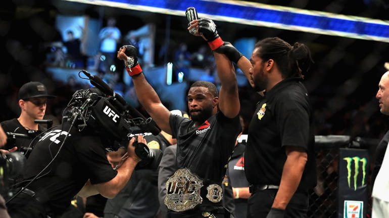 Tyron Woodley reacts to defeating Demian Maia in the welterweight...