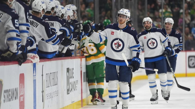 Winnipeg Jets left wing Kyle Connor, front right, celebrates with...