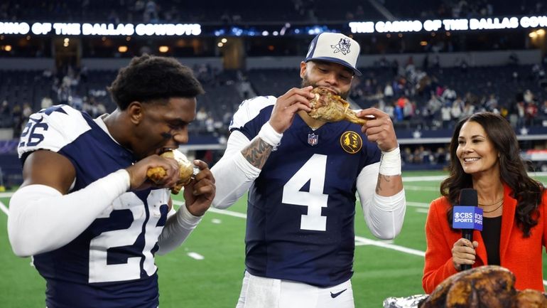 Dallas Cowboys cornerback DaRon Bland, left, and quarterback Dak Prescott...