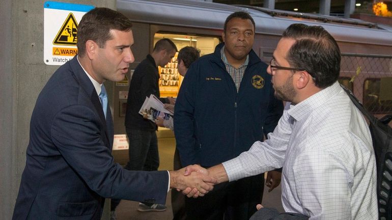 Suffolk County police commissioner Timothy Sini greets commuters and campaigns...