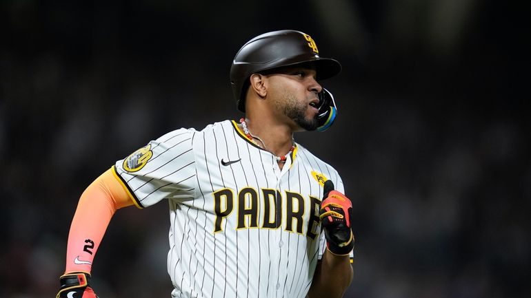 San Diego Padres' Xander Bogaerts watches his RBI single during...