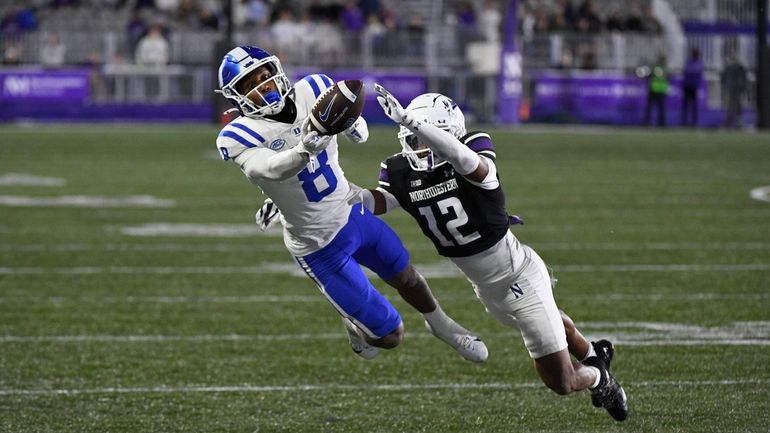 Northwestern defensive back Evan Smith (12) breaks up a pass...