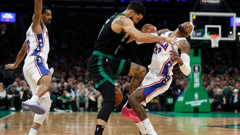 Boston Celtics' Jayson Tatum (0) fouls Philadelphia 76ers' Robert Covington...