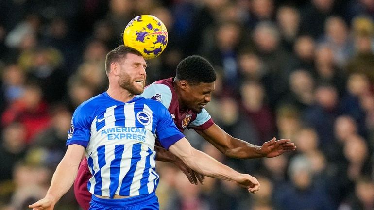 Brighton's James Milner, front, duels for the ball with West...