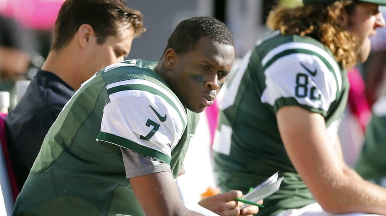 Jets quarterback Geno Smith sits on the bench during the...