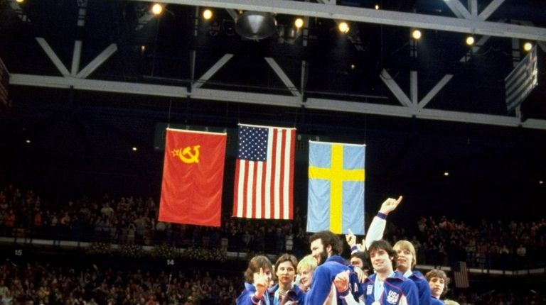 The U.S. hockey team celebrating their gold medal at the...