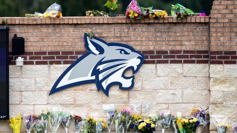 Flowers are displayed at a memorial outside Apalachee High School,...