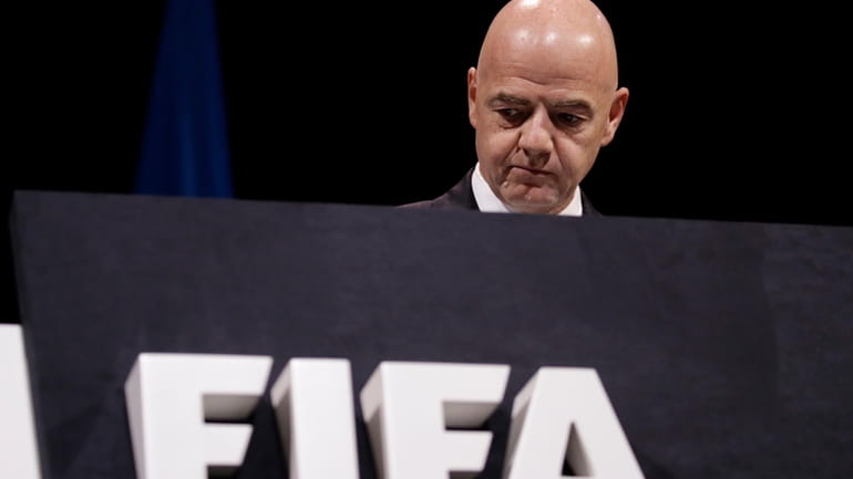 FIFA President Gianni Infantino walks on the stage before the...