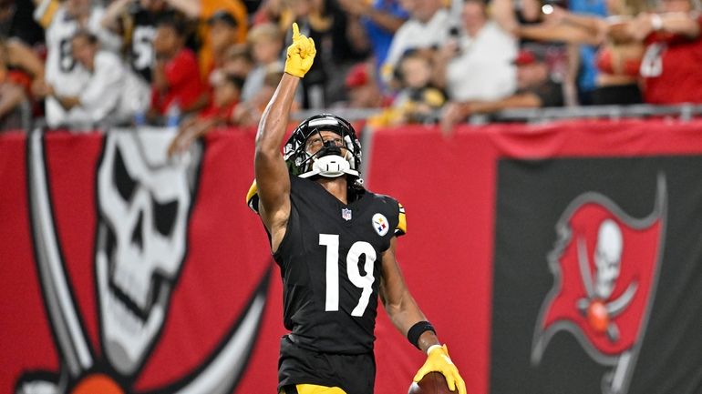 Pittsburgh Steelers wide receiver Calvin Austin III reacts after scoring...