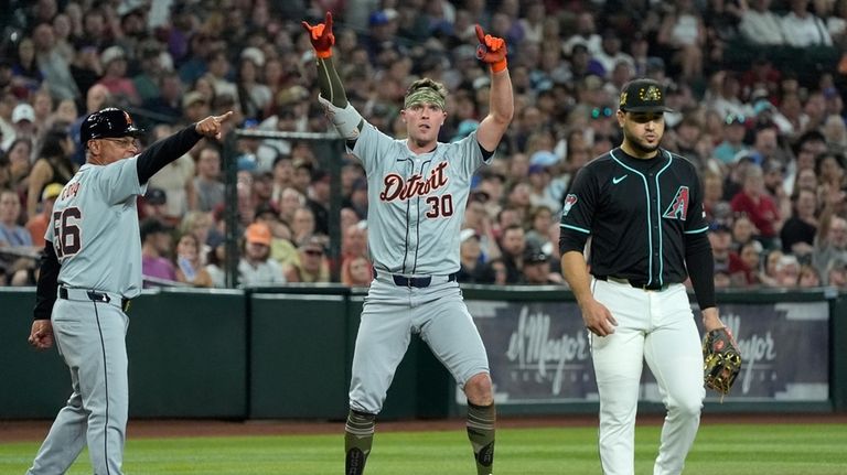 Detroit Tigers' Kerry Carpenter (30) celebrates after his two-run triple...