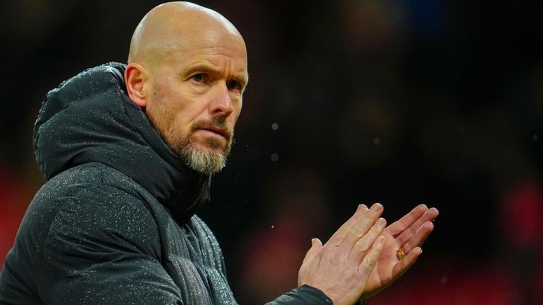 Manchester United's head coach Erik ten Hag applauds to supporters...