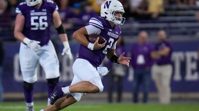 Northwestern quarterback Ben Bryant runs the ball during the first...