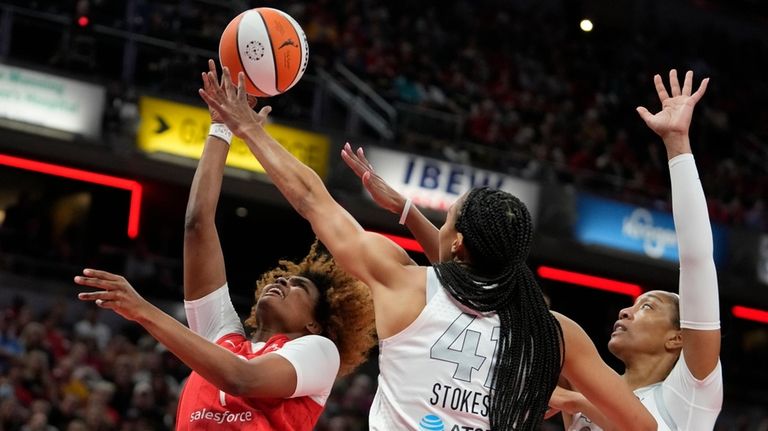 Indiana Fever's NaLyssa Smith (1) shoots over Las Vegas Aces'...