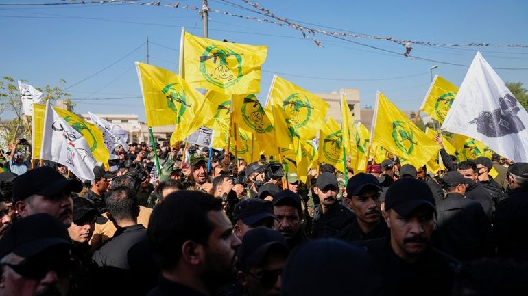 FILE -Members from the Popular Mobilization Forces attend the funeral...