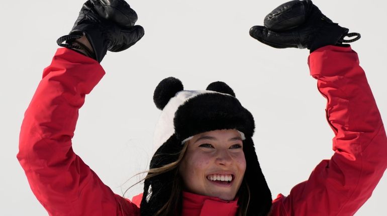 Gold medal winner China's Eileen Gu celebrates during the venue...