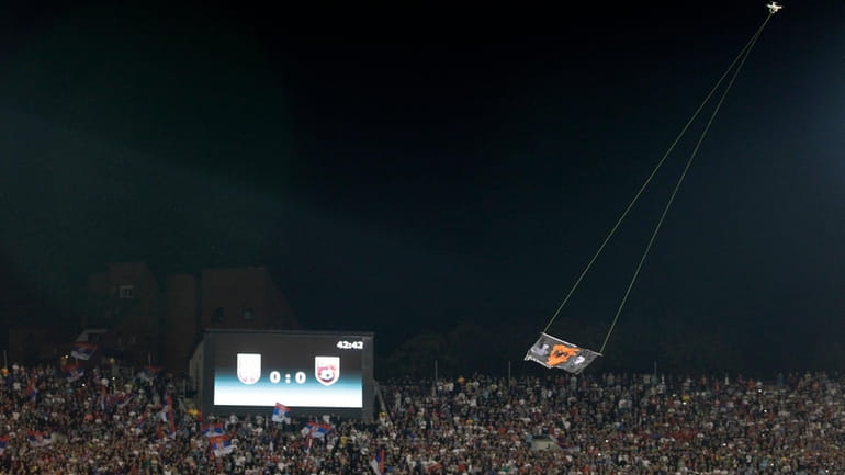 FILE- A drone with an Albanian flag flies over Partizan...