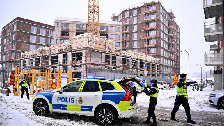 Swedish police arrive at the site where a construction elevator...