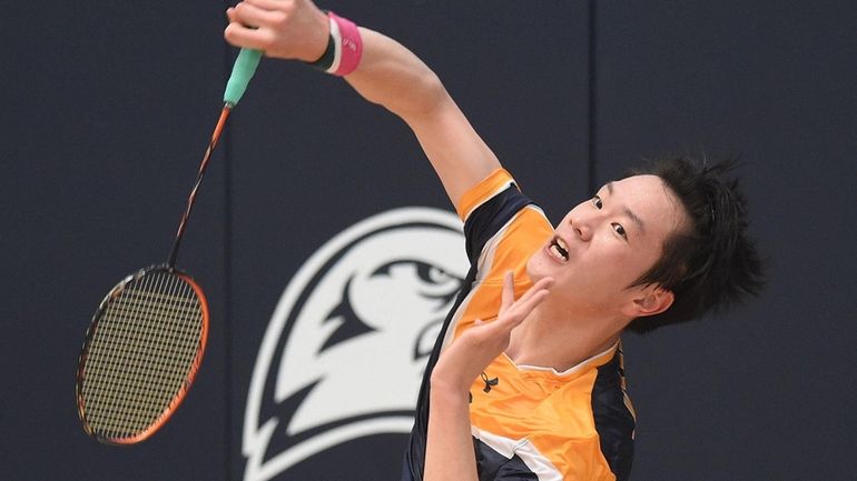 Howard Zheng of Jericho returns a volley in first singles...