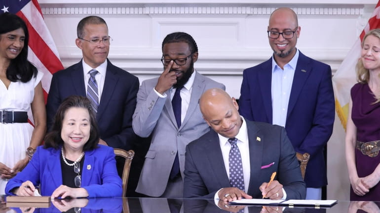 Maryland Gov. Wes Moore signs an executive order to issue...