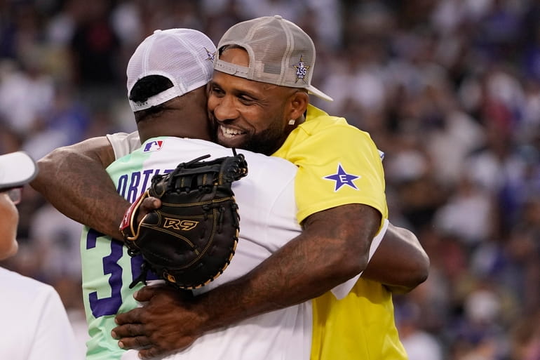 Rapper and singer Bad Bunny runs in the outfield during the MLB