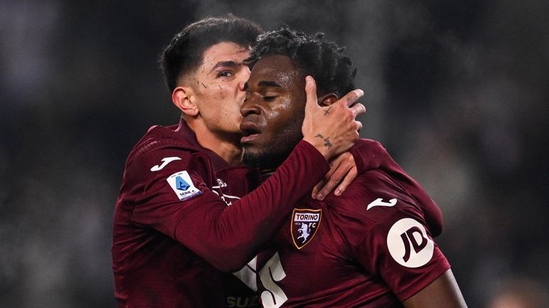 Torino's Duvan Zapata, right, celebrates scoring during the Serie A...