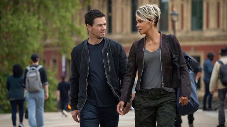 This image released by Netflix shows Mark Wahlberg, left, and...