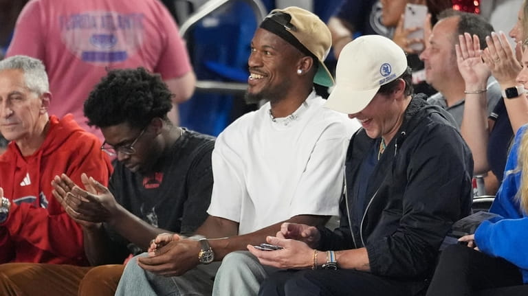 Miami Heat player Jimmy Butler watches the first half of...