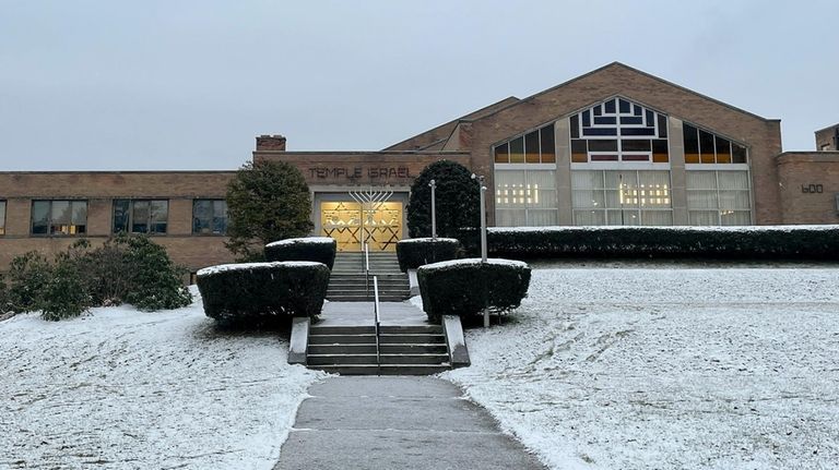 A menorah stands outside the entrance to Temple Israel, Thursday,...