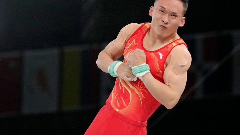 Ruoteng Xiao, of China, competes on the horizontal bar during...