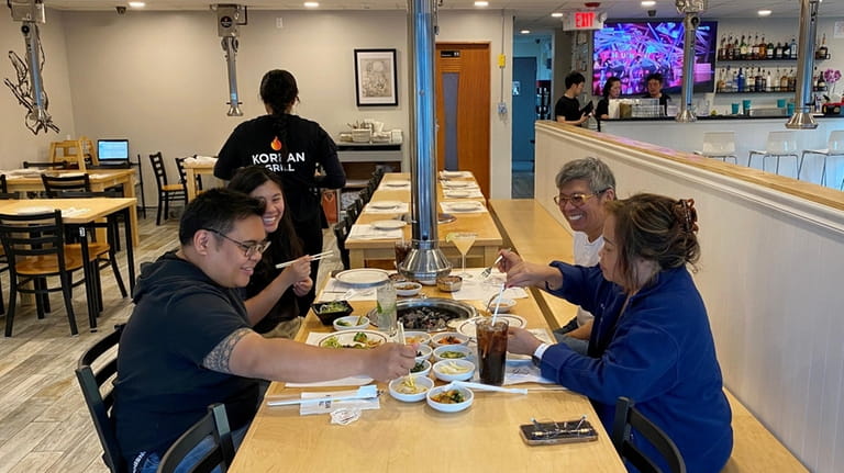 A table for four shares barbecue at Korean Grill in...