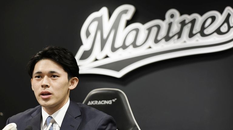 Japan's Lotte Marines pitcher Roki Sasaki speaks at a news...