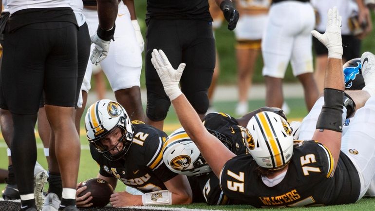 Missouri quarterback Brady Cook (12) looks up after scoring a...