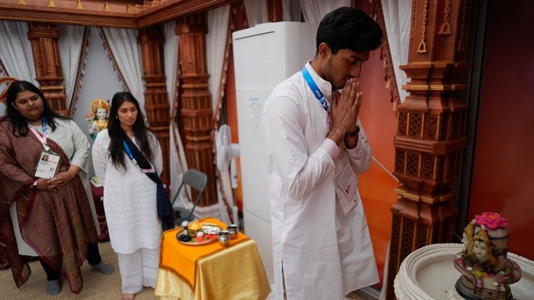 Hindu religious representative Pavitra Patel prays inside the Hindu room...