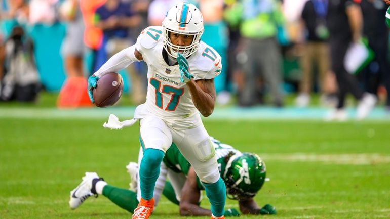 Miami Dolphins wide receiver Jaylen Waddle (17) runs with the...