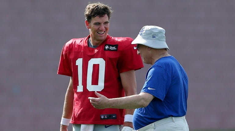Giants general manager Dave Gettleman talks to quarterback Eli Manning...