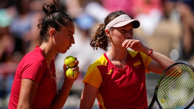 Cristina Bucsa and Sara Sorribes Tormo of Spain talk as...