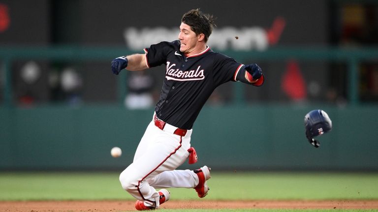 Washington Nationals' Jacob Young slides to second base with a...