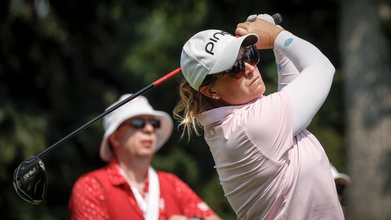 Lauren Coughlin, of the United States, hits a tee shot...