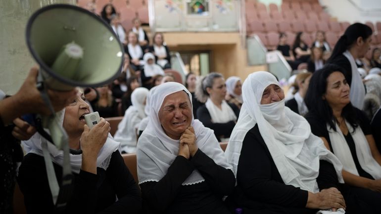 Members of the Druze minority attend a memorial ceremony, Monday,...