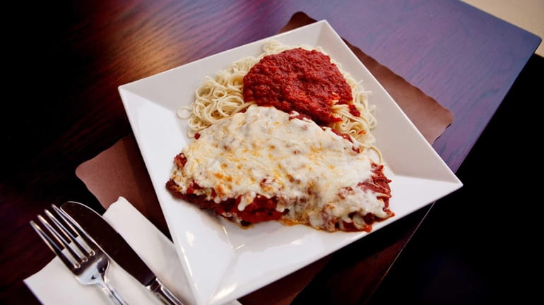 Chicken Parmigiana is tender and savory, served with al dente...