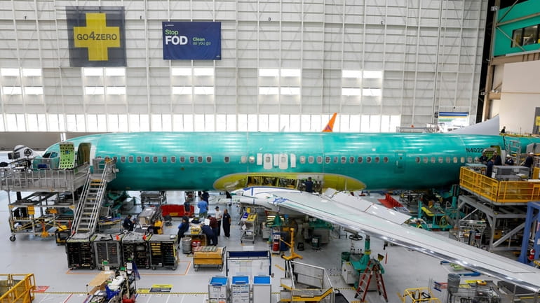 A Boeing 737 MAX aircraft is shown on the assembly...