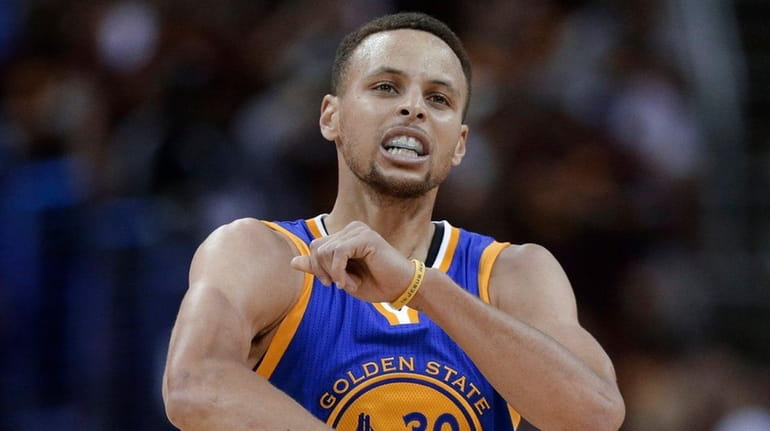 Golden State Warriors guard Stephen Curry celebrates a basket against...
