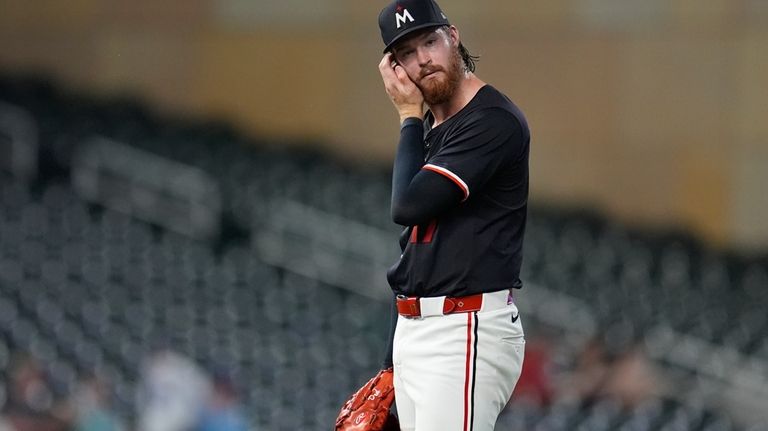 Minnesota Twins starting pitcher Bailey Ober reacts after a two-run...