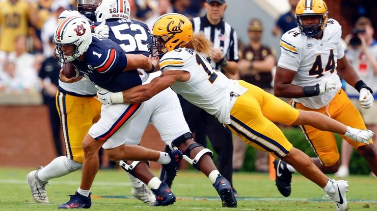 Auburn quarterback Payton Thorne (1) is tackled by California linebacker...