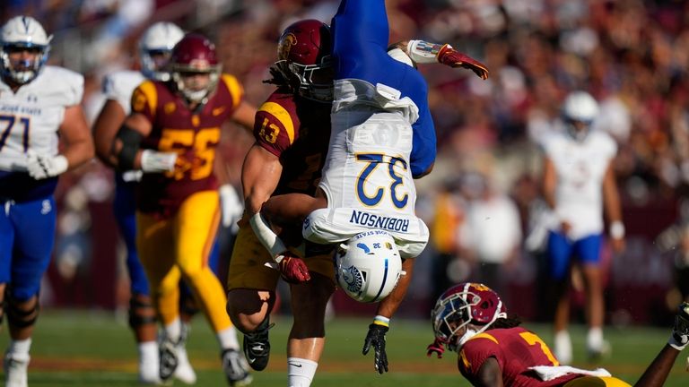 San Jose State running back Kairee Robinson (32) is grabbed...