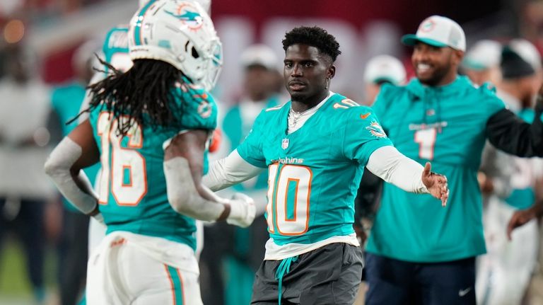 Miami Dolphins wide receiver Tyreek Hill (10) greets players as...