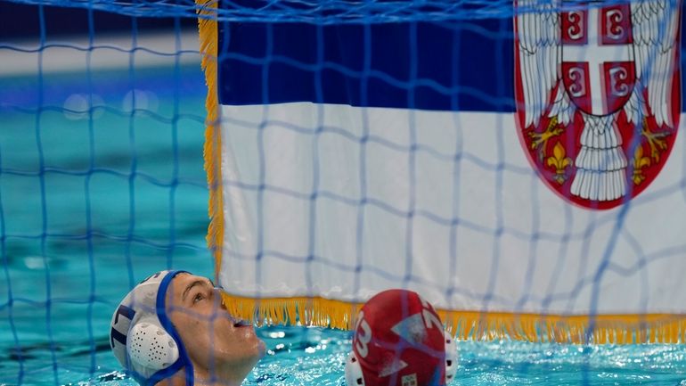 Serbia's Petar Jaksic celebrates winning the men's water polo gold...